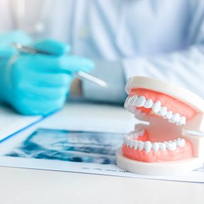 Dentist in Ramsey discussing alternatives to dentures