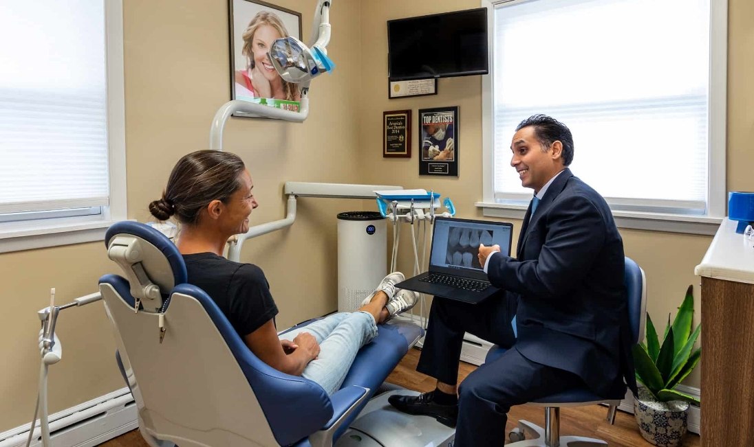 Doctor Vahid talking to a dental patient in Ramsey
